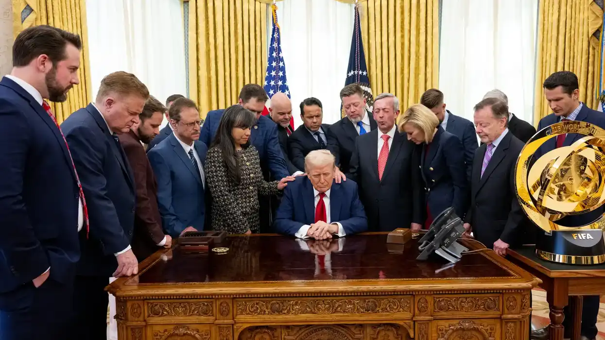 Evangelical leaders pray over President Donald Trump in the Oval Office.