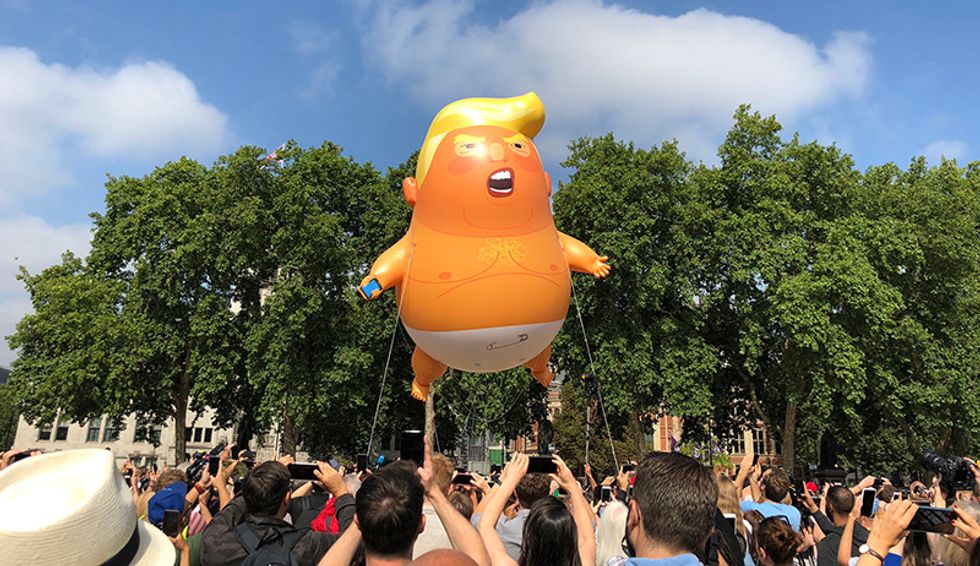 Knife-wielding woman stabs giant Trump balloon in the diaper