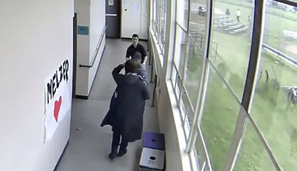 Football coach disarms and hugs student who held a loaded shotgun: newly-released footage