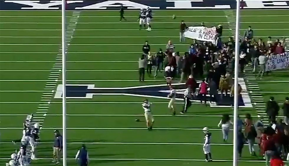 'OK boomer': Hundreds of activists delay Harvard-Yale football game for climate protest