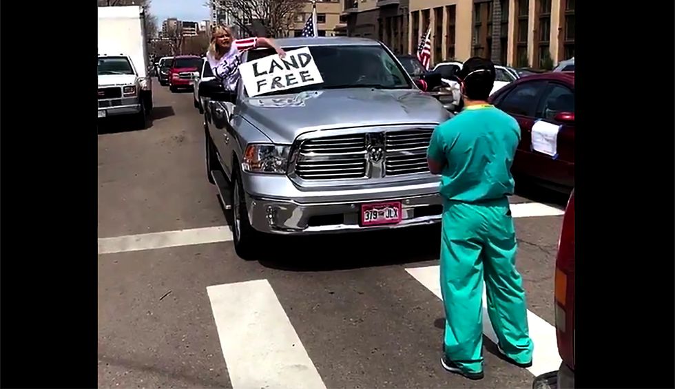 Watch: Nurses stand in the street to silently protest anti-lockdown demonstrators in Colorado