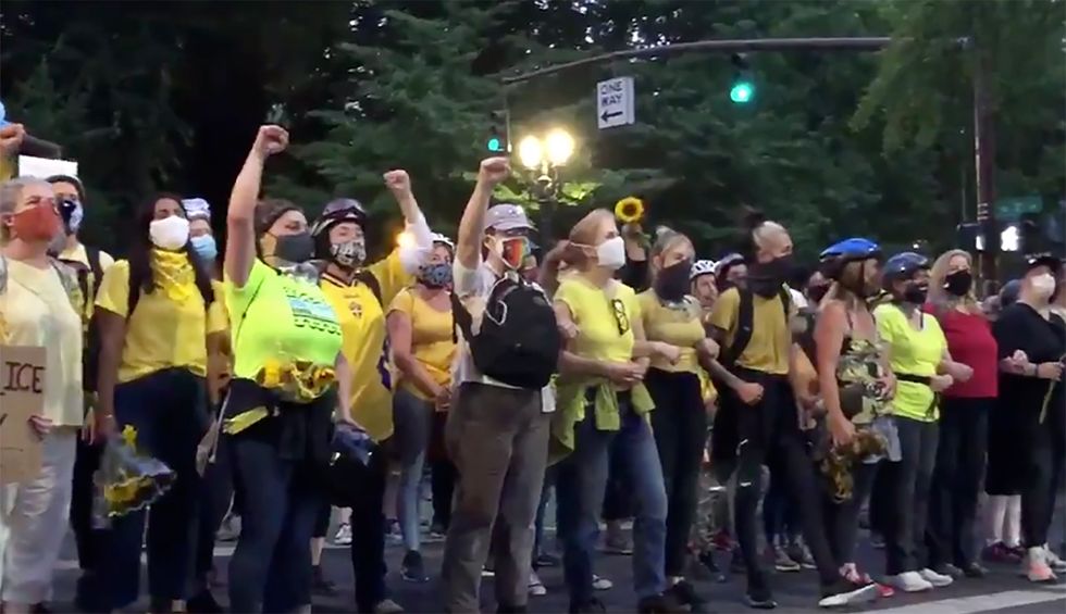 Police goons are tear-gassing sunflower-wielding moms as they defend Portland BLM protestors