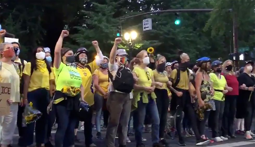Police goons are tear-gassing sunflower-wielding moms as they defend Portland BLM protestors