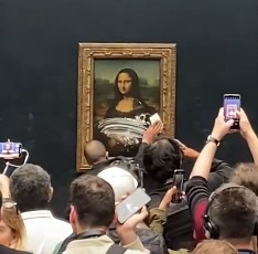 Visitor throws cake at the 'Mona Lisa' in Paris' Louvre
