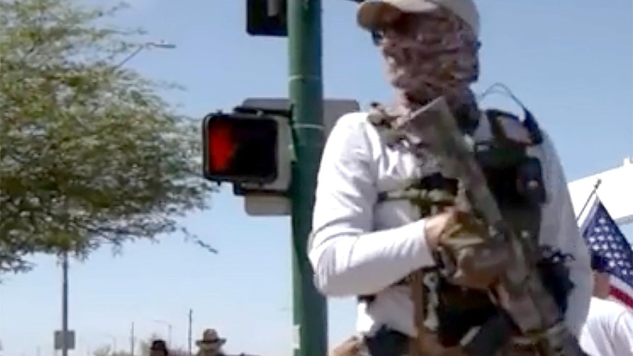 'We will not stand by and we will not stand down': Armed Trump supporters protest at Phoenix FBI office