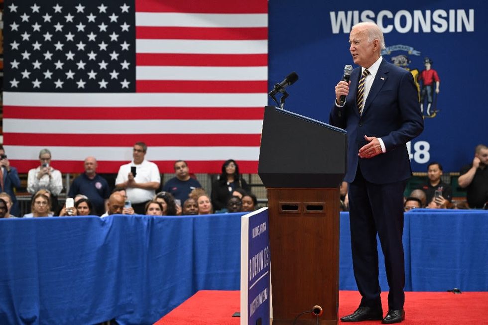 As Trump wrestles indictments, Biden keeps focus on economy