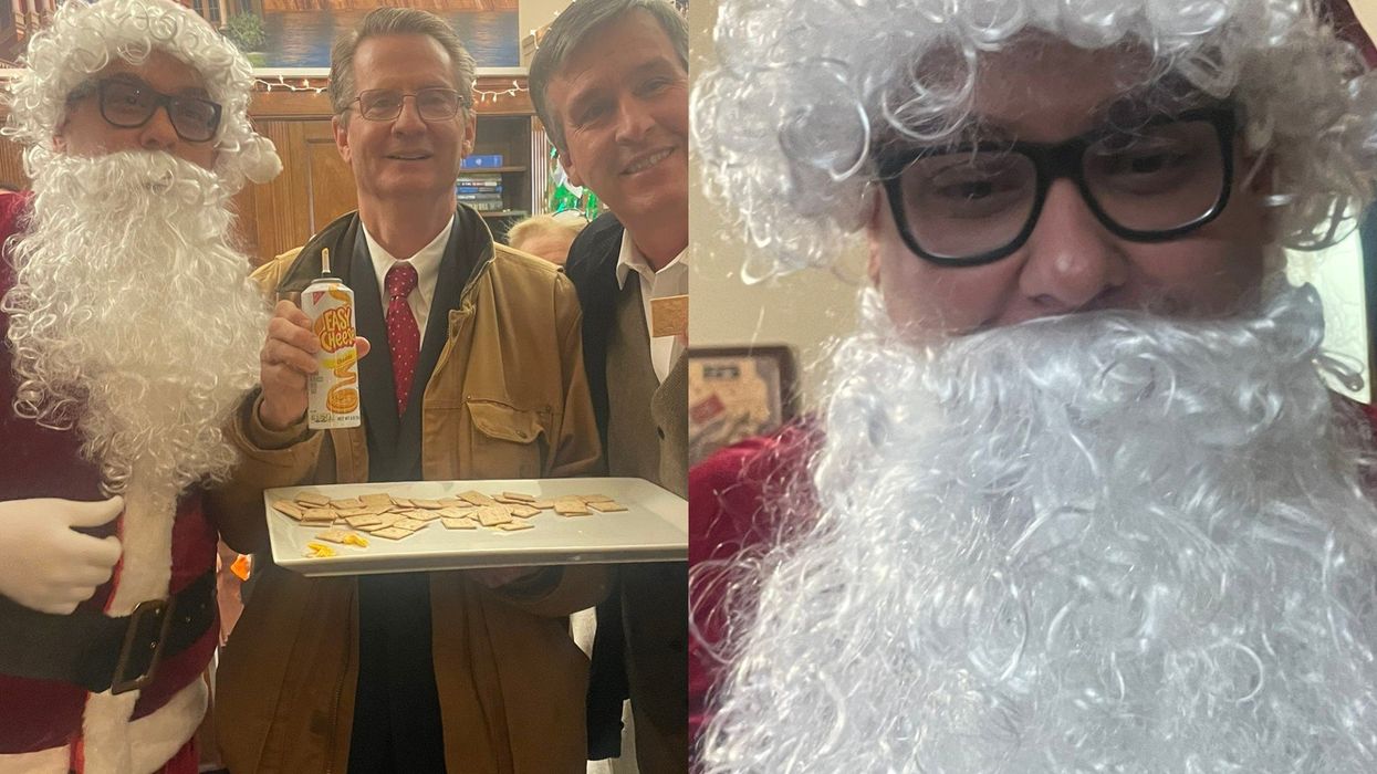 George 'Santos Claus' hands out treats in red suit and fake beard at GOP rep’s office