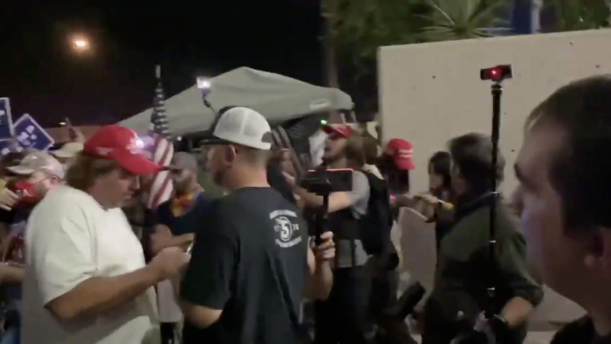 Arizona officials vow to 'continue our job' as armed Trump backers gather at local election building