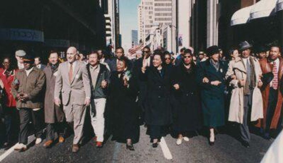 Ira Glasser (at left in beige suit) marching in Atlanta, GA, with Coretta Scott King (center) and others in 1997 Martin Luther King, Jr. Day parade.