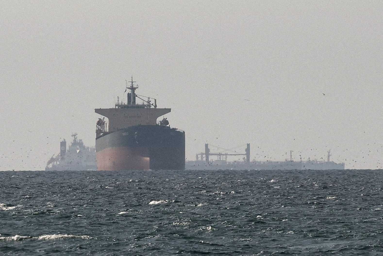 Cargo ships in the Gulf, near the Strait of Hormuz, as seen from northern Ras al-Khaimah, near the border with Oman’s Musandam governance, amid the U.S.-Israeli conflict with Iran, in United Arab Emirates, March 11, 2026.