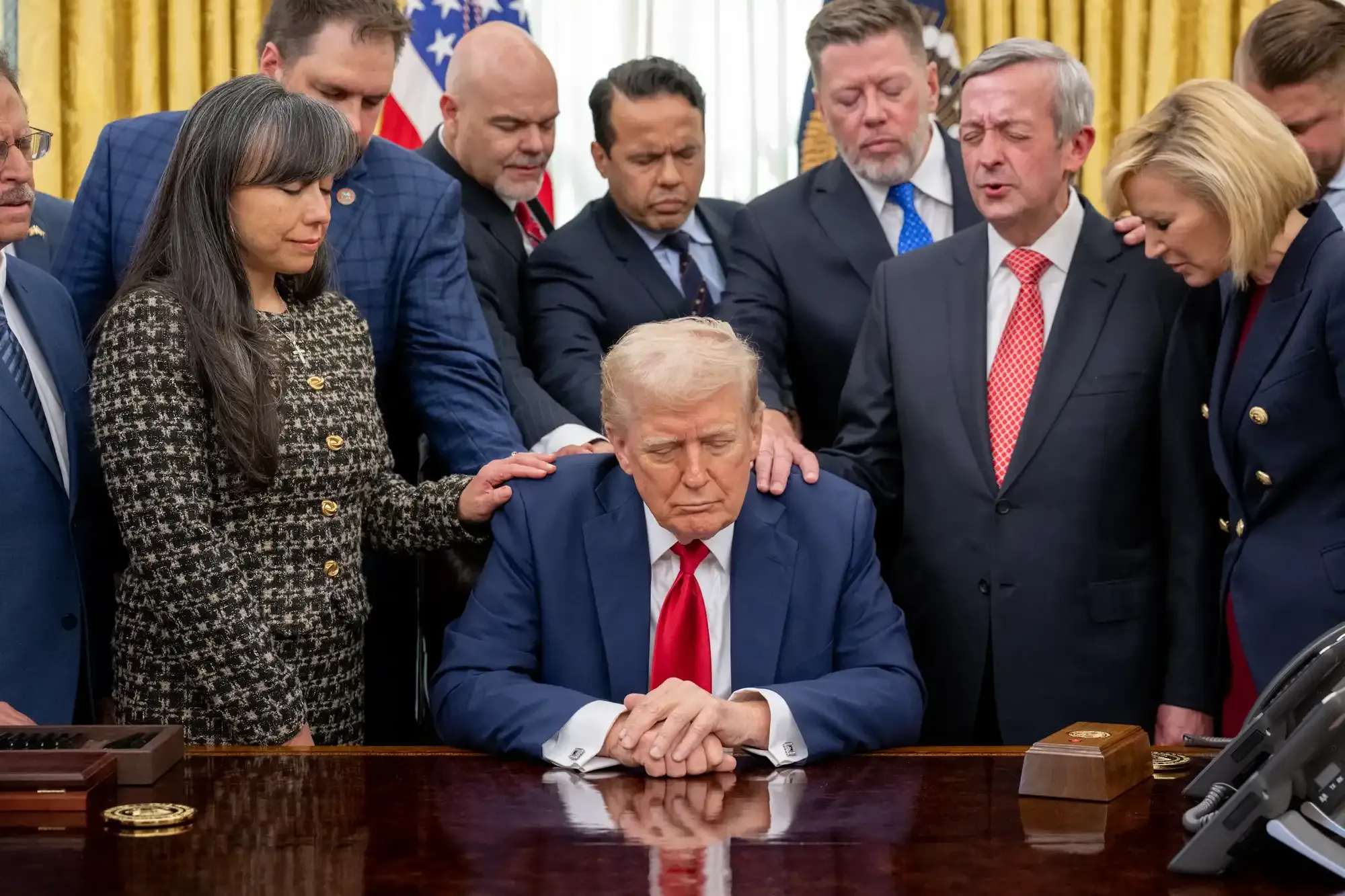 Faith leaders pray over President Donald Trump in the Oval Office. Image courtesy of The White House.