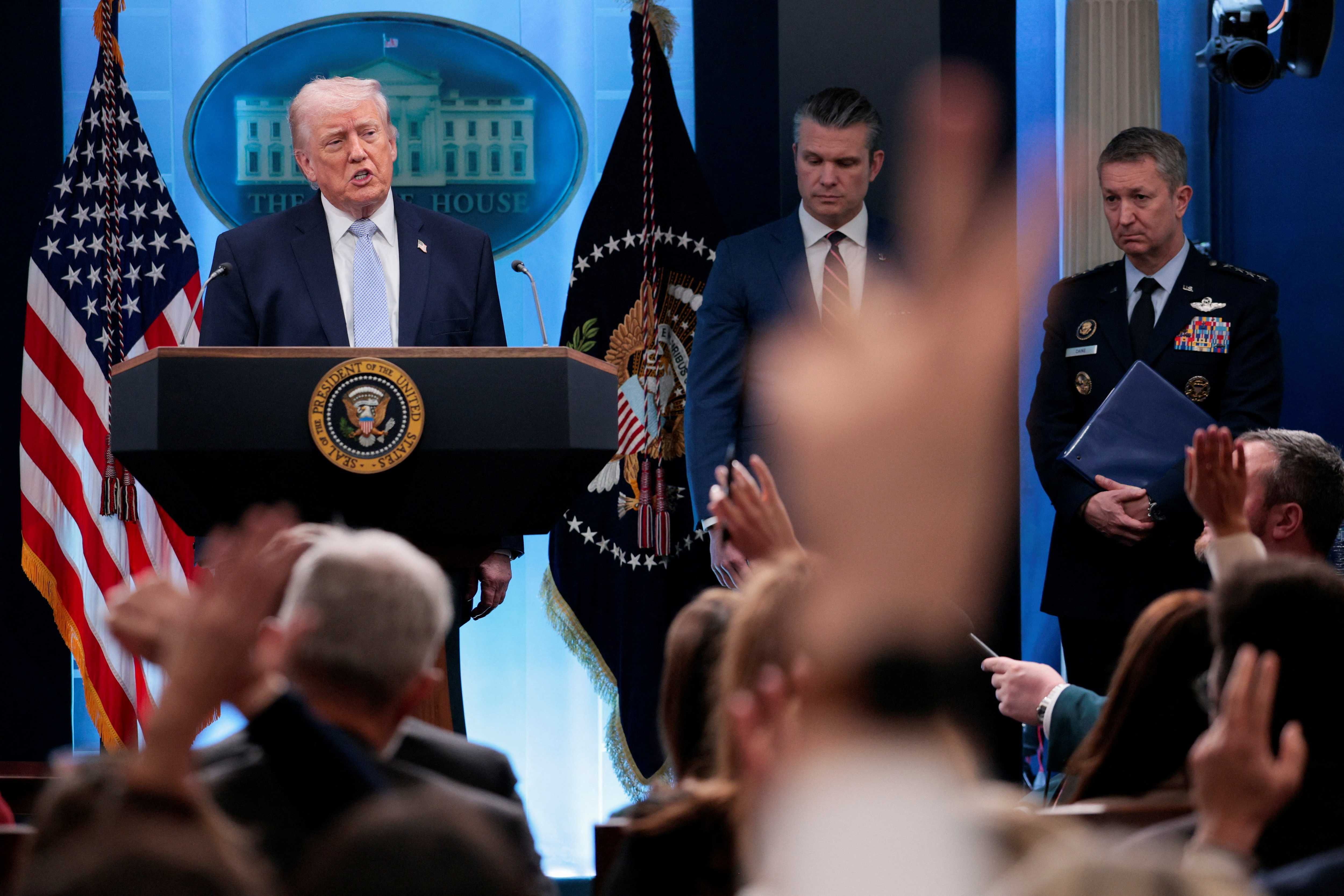 Reporters raise their hands to ask questions as President Donald Trump holds a press conference in the James S. Brady Press Briefing Room at the White House in Washington, D.C., April 6, 2026. REUTERS/Evan Vucci