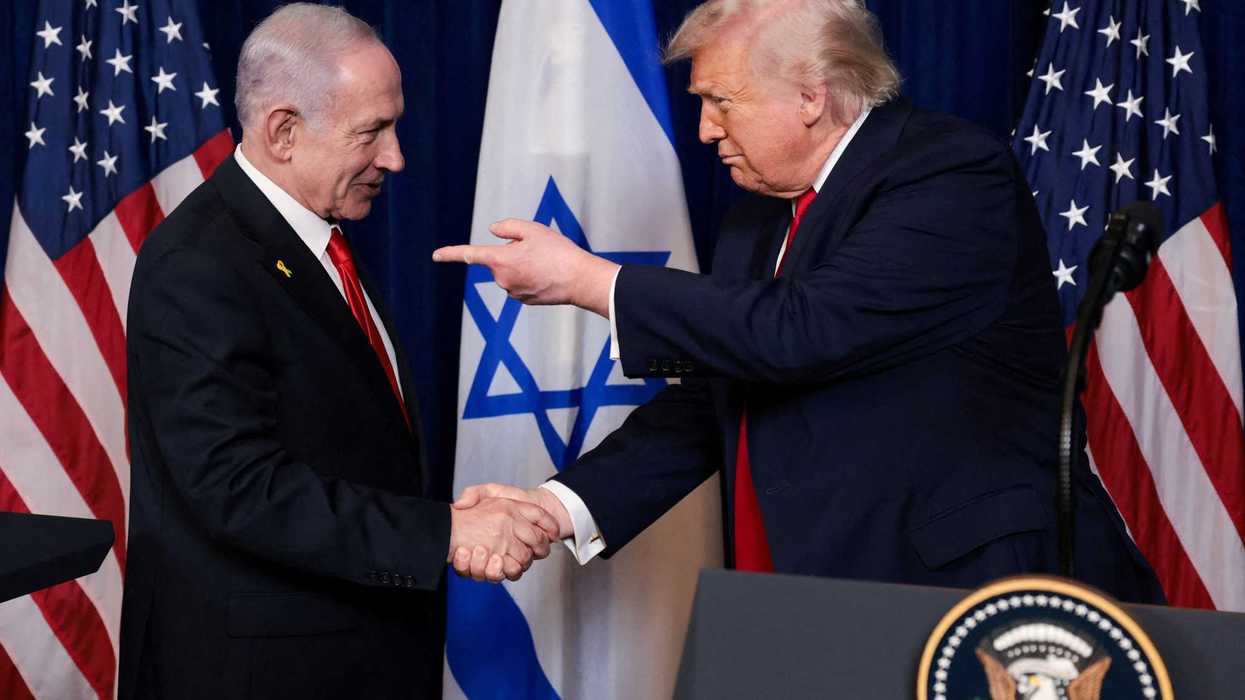 U.S. President Donald Trump points his finger towards Israeli Prime Minister Benjamin Netanyahu as they shake hands during a press conference after meeting at Trump’s Mar-a-Lago club in Palm Beach, Florida, U.S., December 29, 2025.